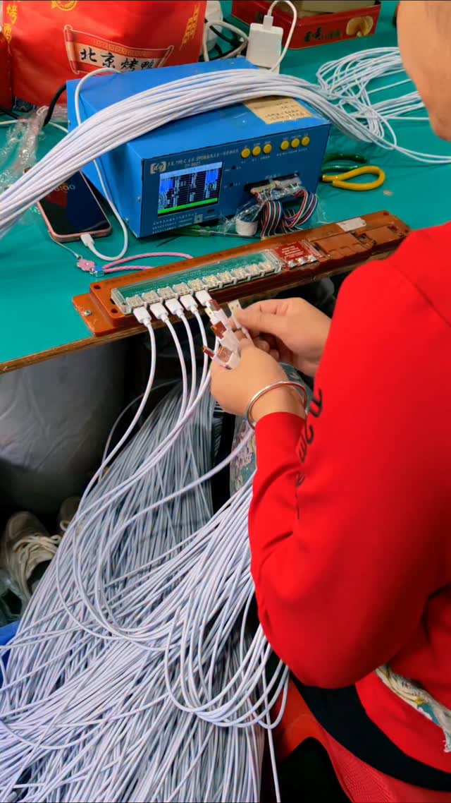 A high-volume cable testing and quality control station within an electronics manufacturing facility…